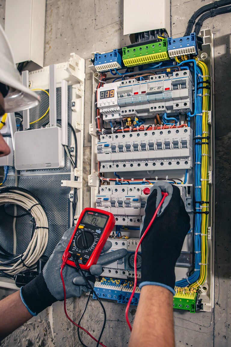 man electrical technician working switchboard with fuses 1